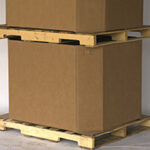 Two heavy-duty corrugated boxes are stacked on top of each other on a wooden pallet.