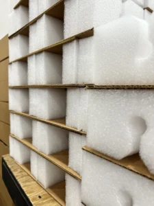 Foam packaging inserts with corrugated dividers designed to absorb shock and vibration